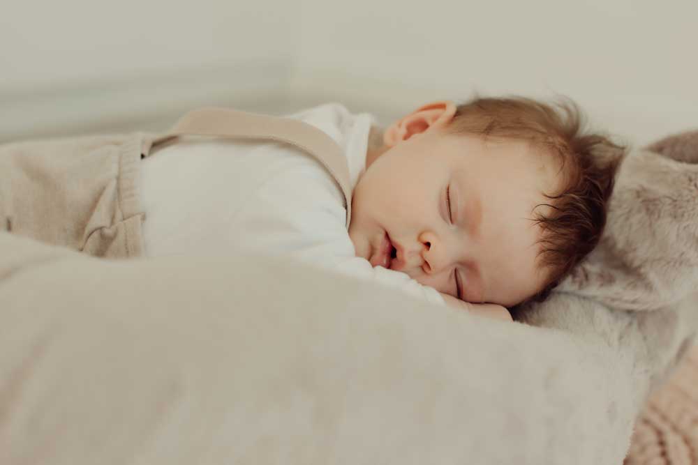 baby asleep in bed