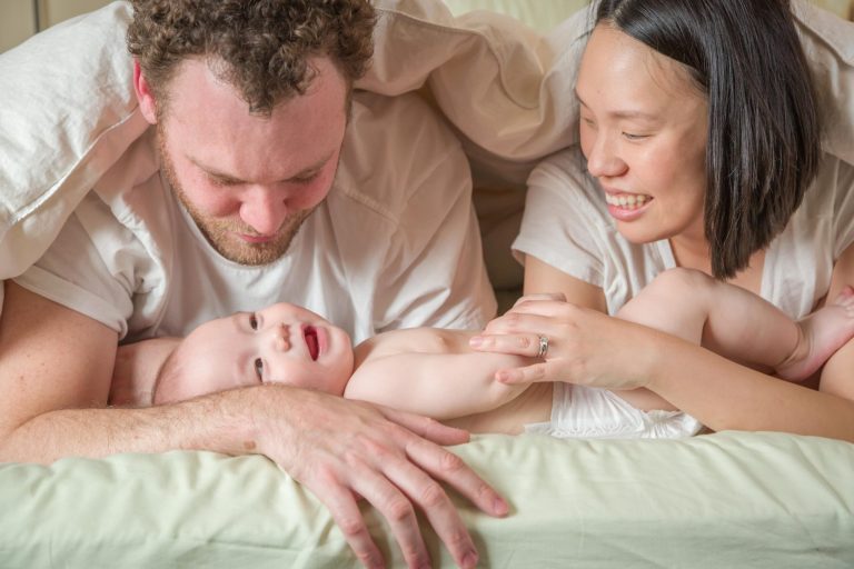parents looking proudly at their smiling baby